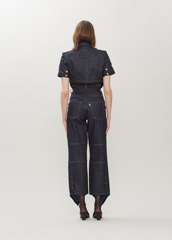 Raw Indigo Quinn Jean Lightweight denim with a high-rise relaxed straight leg featuring drop pockets with snap closure, v-shaped front hem, and buttons at back for option to cinch at ankle. Each pair has a branded enameled button.Styled with The Quinn Bolero | The Chloe Corset | The Zoey Tank