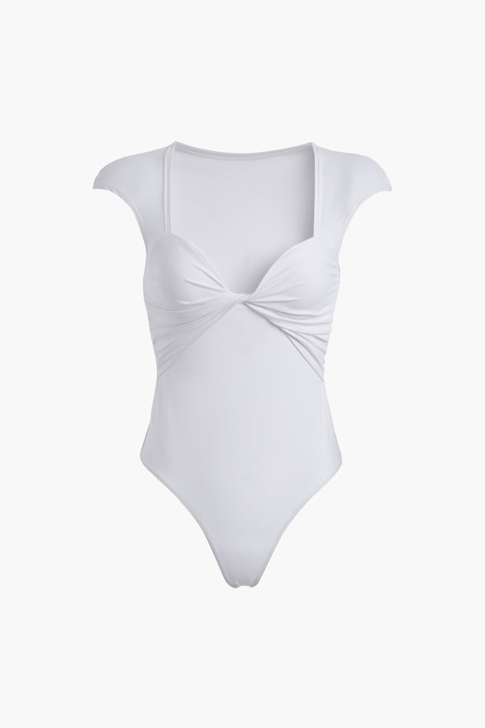 White RAE BODYSUIT This bodysuit features a twisted ruched bust, fitted cap-sleeve shoulder and timelesss silhouette. *All sale merchandise is exchangeable for size only.