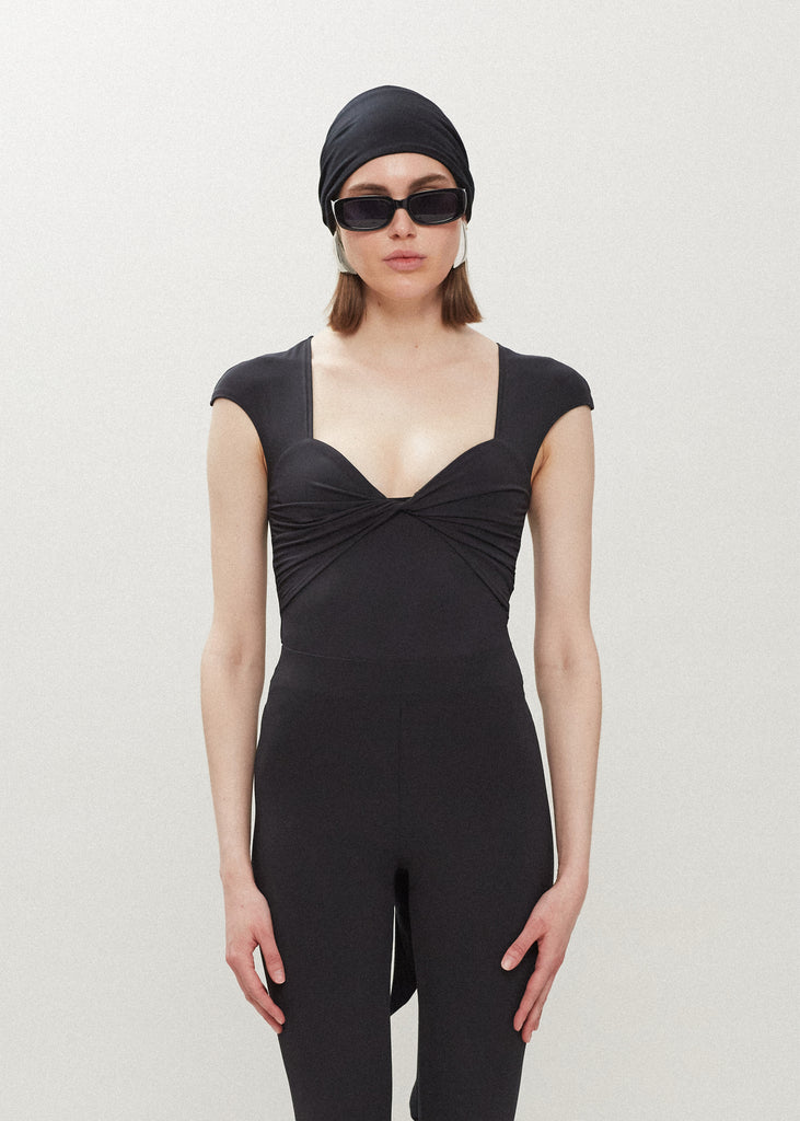 Black Rae Bodysuit This bodysuit features a twisted ruched bust, fitted cap-sleeve shoulder and timelesss silhouette. FINAL SALE 