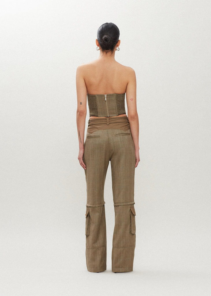 Camel Herringbone Ronnie Trouser High-rise lightweight tailored trouser featuring contrasting waistband with self-fabric tie tunneled through two rows of belt loops. Featuring a relaxed leg fit with cargo style pockets and horn buttons.