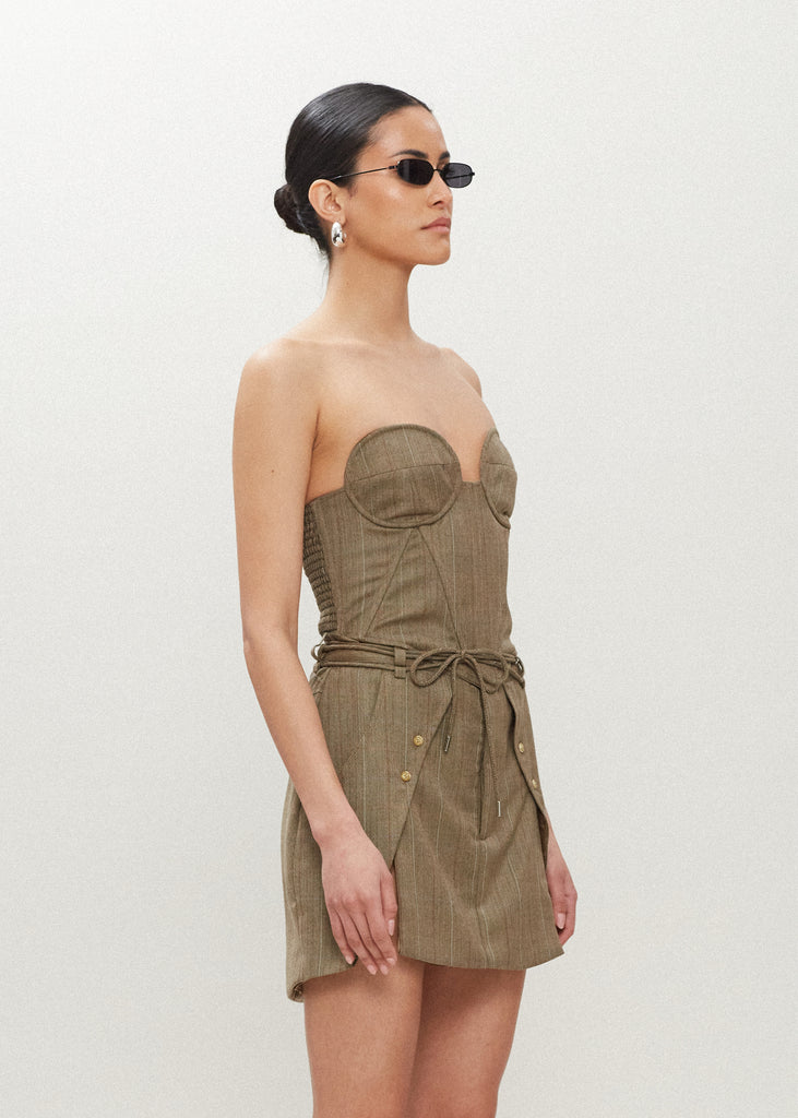 Camel Herringbone Ronnie Skirt Paneled skirt featuring a self-fabric waist tie tunneled through two rows of belt loops. Double front vents are secured by horn buttons. Slightly lengthened back for added coverage. 