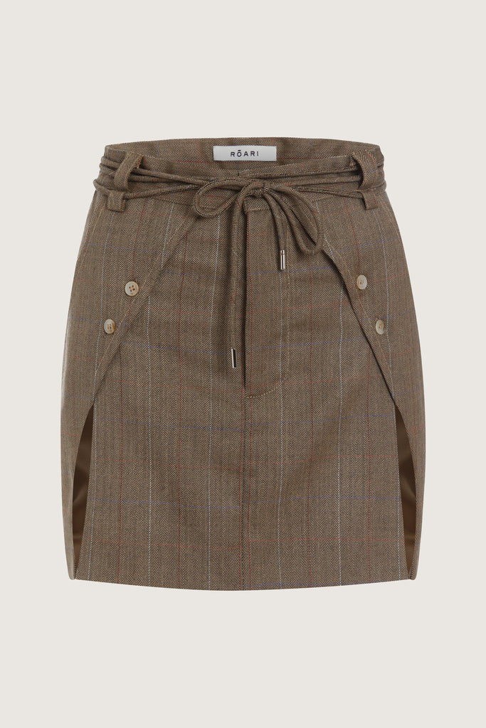 Camel Herringbone Ronnie Skirt Paneled skirt featuring a self-fabric waist tie tunneled through two rows of belt loops. Double front vents are secured by horn buttons. Slightly lengthened back for added coverage.Style with The Ronnie Blazer | The Ronnie CorsetAll items marked down are FINAL SALE.