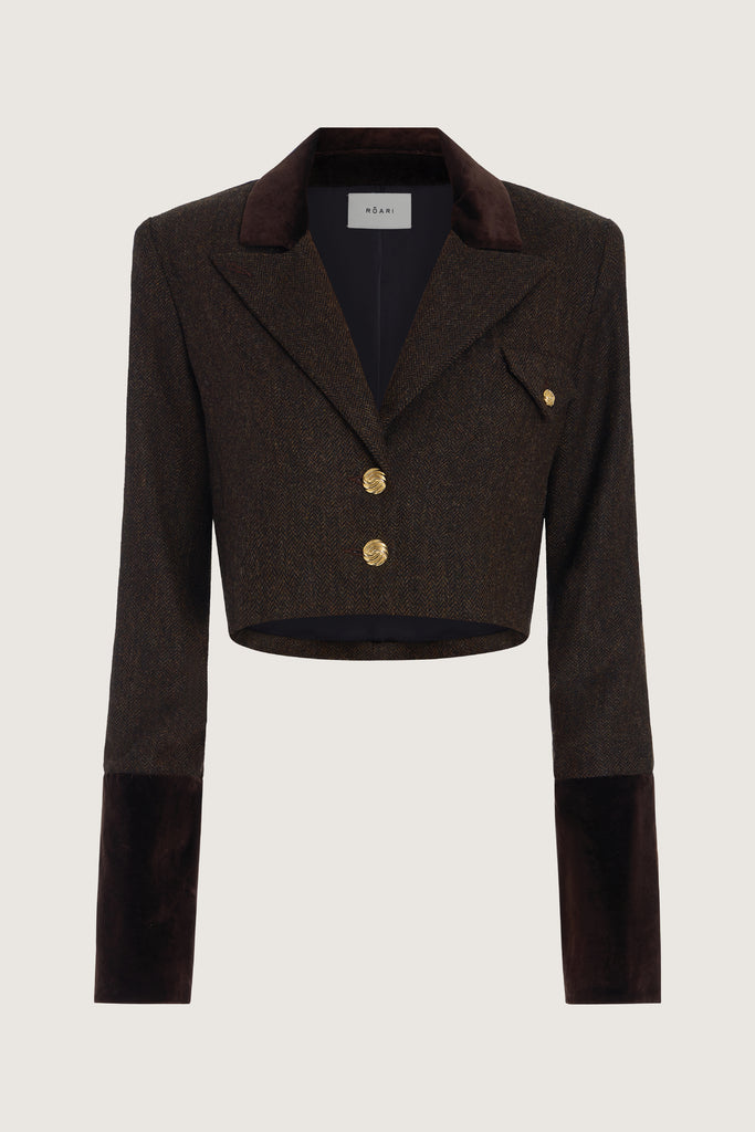 Brown Herringbone Camilo Jacket The Camilo Jacket: A fusion of classic tailoring and refined detailing, this cropped jacket elevates timeless tweed with modern touches.-Cropped herringbone blazer -Soft Merino wool-Contrast velvet combo fabric at the collar and lapel-Flap pocket with single gold knot button closure-Structured padded shoulder -Gold knot buttons at center front-Gold knot button on exterior cuff-Fully lined Crafted with Merino wool certified by the Wool Integrity Programme, ensuring farms adhere to the Five Freedoms of animal welfare. We recommend ordering your usual size.Styled with the Raymond Trouser, Zoey Tank, & Kate Short