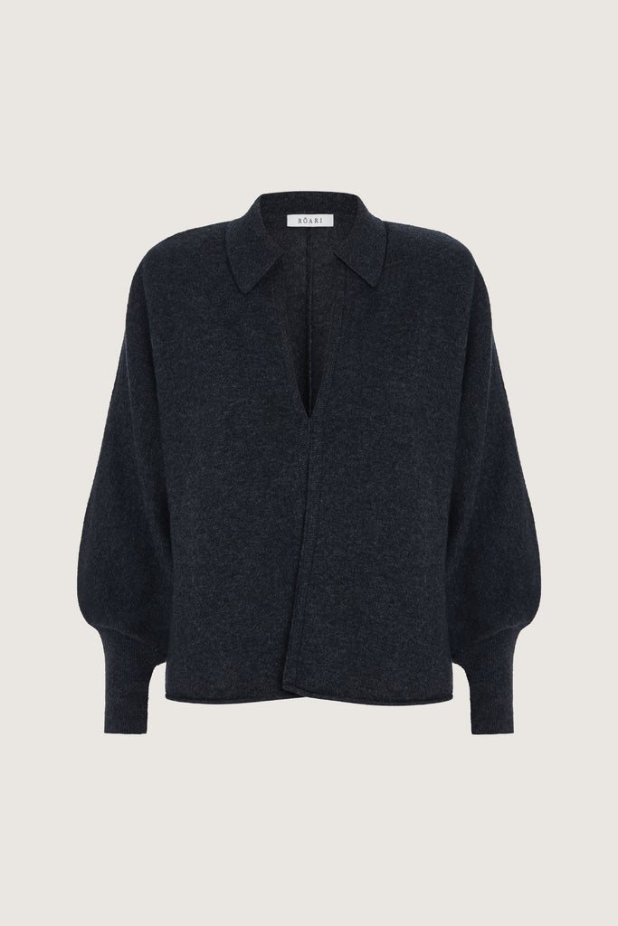 Charcoal Nico Shirt A seamless blend of soft comfort, style, and conscious sourcing, creating an essential you'll reach for again and again. -Collared open cardigan-Single hook and eye closure-Rib knit collar-Tailored ribbed cuffs-Dolman sleeves-Hip length-Rolled bottom hem-Self covered removable shoulder pads🐑 Made with Good Cashmere Standard® wool to support the welfare of cashmere goats We recommend ordering your usual size.Styled with the Beverly Trouser