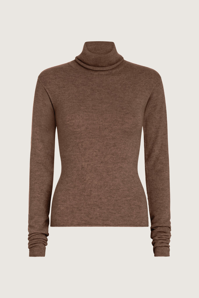 Brown Olivia Turtleneck Delicately soft and consciously crafted, it's the perfect foundation for any outfit.-Classic turtleneck silhouette -Extra-long neck trim for versatile styling (folding and stacking)-Long sleeves designed for slight stacking at the wrist-Rolled wrist and bottom hem 🐑 Made with Good Cashmere Standard® wool to support the welfare of cashmere goats We recommend ordering your usual size.Styled with the Ava Skirt