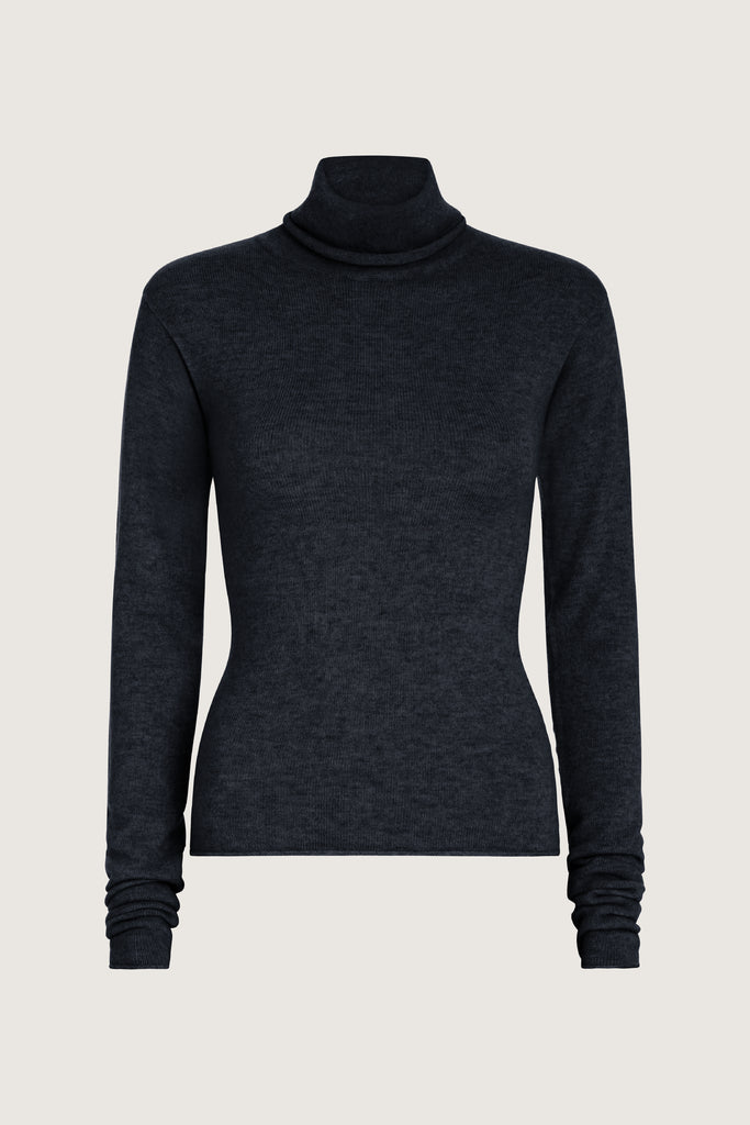 Charcoal Olivia Turtleneck Delicately soft and consciously crafted, it's the perfect foundation for any outfit.-Classic turtleneck silhouette -Extra-long neck trim for versatile styling (folding and stacking)-Long sleeves designed for slight stacking at the wrist-Rolled wrist and bottom hem 🐑 Made with Good Cashmere Standard® wool to support the welfare of cashmere goats We recommend ordering your usual size.Styled with the Ava Skirt