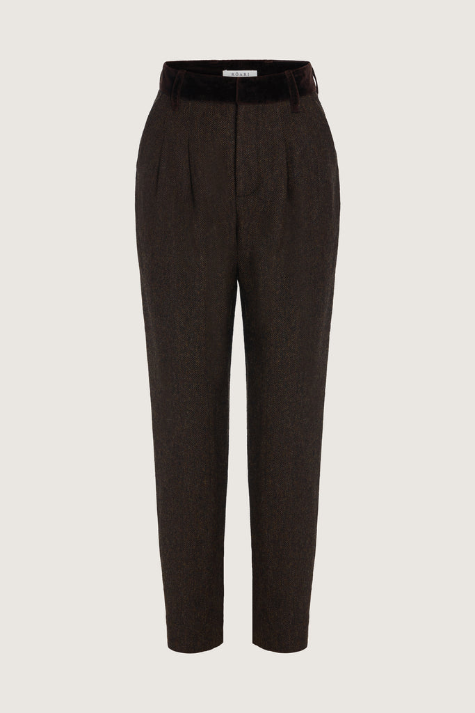 Brown Herringbone Raymond Trouser Expertly tailored in a silhouette that echoes the collection's blend of classic tailoring and modern details. -Straight leg ankle length trouser-Smooth velvet combo waistband-Double-pleated front-Slant front pockets-Self-doubled belt loops-Zip fly with hook and bar closure-Faux welt back pockets-Fully lined for superior comfort and drape 🐑 Crafted with Merino wool certified by the Wool Integrity Programme, ensuring farms adhere to the Five Freedoms of animal welfare. We recommend ordering your usual size.Styled with the Camilo Jacket & Zoey Tank