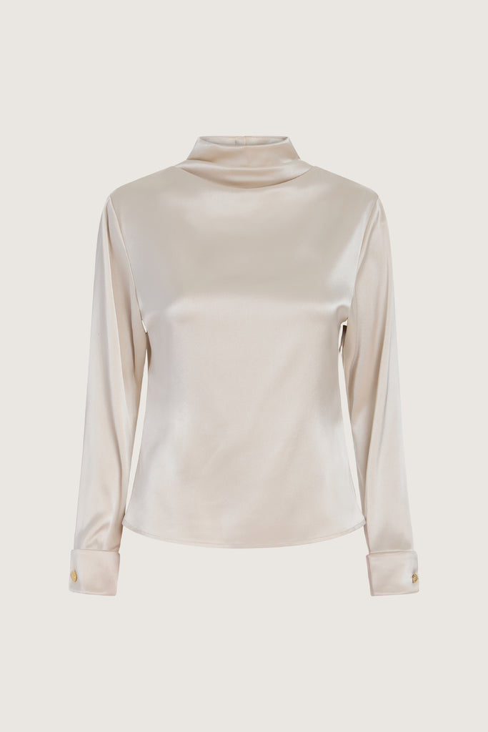 Champagne Vivien LS Top Elevate your wardrobe with this silky-soft and versatile satin top.-Cowl neckline with stacked collar-Self-loops with gold knot buttons at back neck-Removable shoulder pads with interior pockets-Hidden zip at back-Turnback cuff with gold knot button-Fluid drape with tailored structure-Finished with French seamsWe recommend ordering your usual size.Styled with the Vivien Pant & Ava Skirt