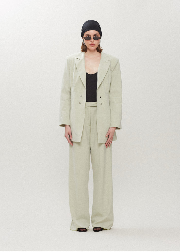 Sage Rhodes Blazer This mid-length blazer features a detachable waist tie, allowing you to create a range of looks. The tailored single- breasted style features shoulder pads and front welt pockets. The Kat Trouser compliments the blazer perfectly.