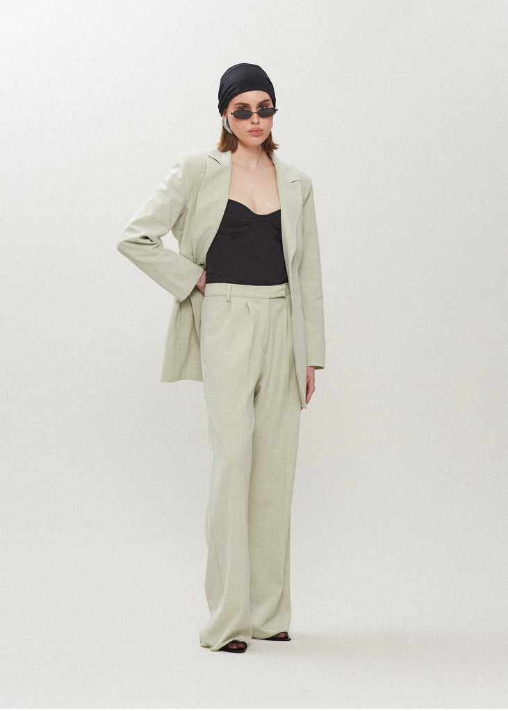 Sage Kat Trouser Dual pleated mid-rise trousers featuring a straight, relaxed fit. Pockets at back with horn buttons. Includes a self-fabric detachable belt. Styled with The Rhodes Blazer | The Lily Bodysuit | The Jamie WrapSALE MERCHANDISE IS EXCHANGE OR STORE CREDIT ONLY
