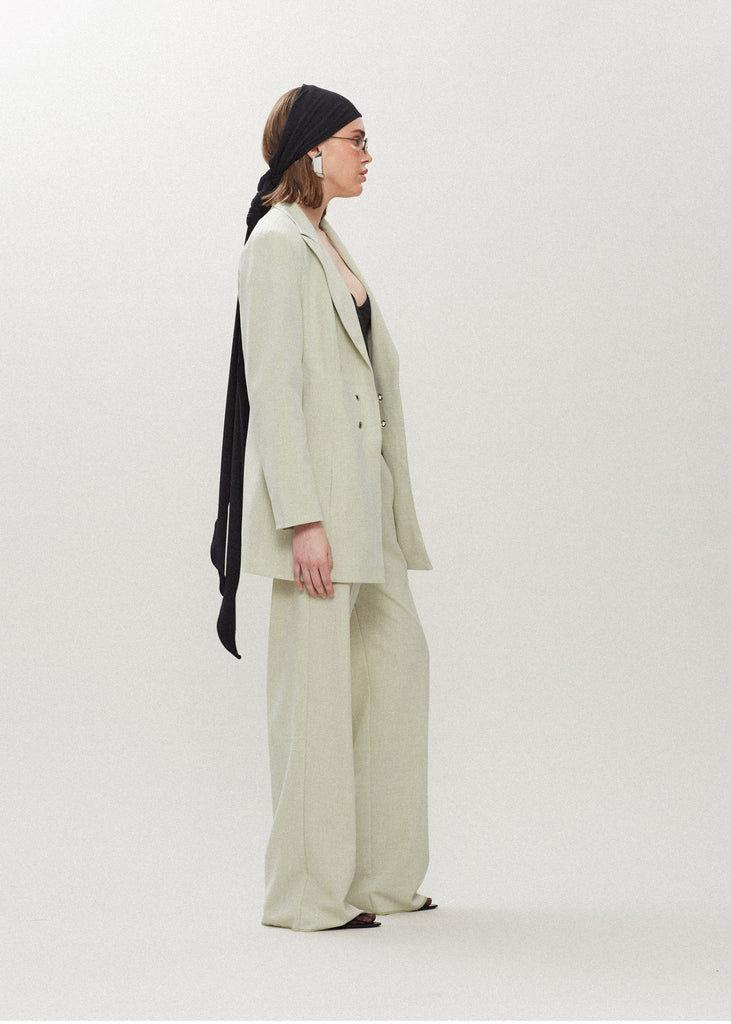 Sage Kat Trouser | The Archive Dual pleated mid-rise trousers featuring a straight, relaxed fit. Pockets at back with horn buttons. Includes a self-fabric detachable belt. Styled with The Rhodes Blazer | The Lily Bodysuit | The Jamie WrapAll items within The Archive Collection are FINAL SALE.Subscribe to our newsletter to unlock an additional offer exclusive to the archive sale.