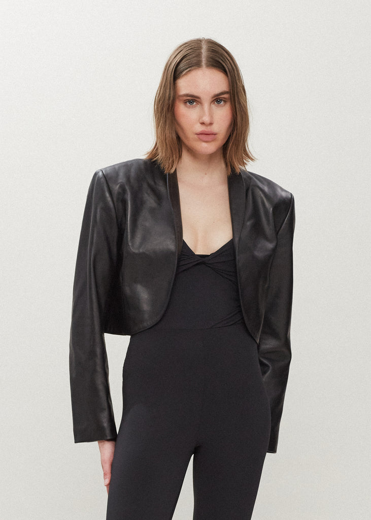 Black Saint Bolero This cropped bolero-style jacket is cut from luxurious Italian leather. It features an open front, internal zip-pocket, and shoulder pads for added structure.