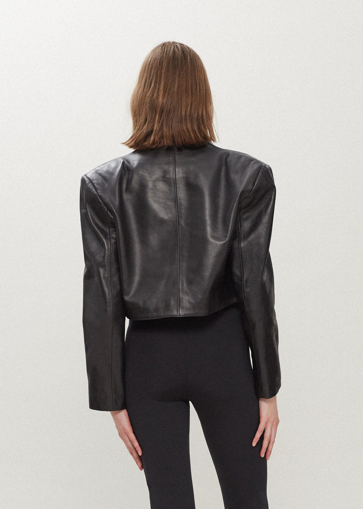 Black Saint Bolero This cropped bolero-style jacket is cut from luxurious Italian leather. It features an open front, internal zip-pocket, and shoulder pads for added structure.