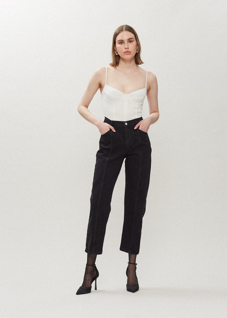 Faded Black Sarah Jean Vintage inspired high-rise jean with a relaxed straight-leg, cropped ankle length and seams down the front. Each hand-finished pair has a branded enameled button. 100% cotton. Made in New York. *Due to the nature of this custom wash we suggest sizing up 1-2 sizes.