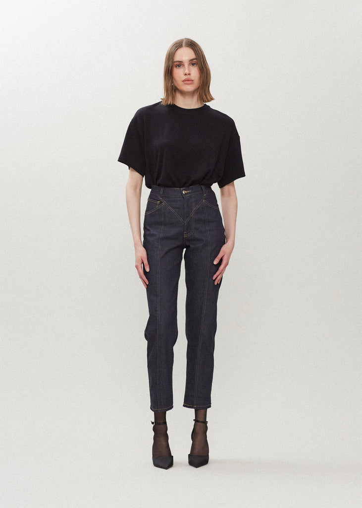 Raw Indigo Sarah Stretch Jean Vintage inspired high-rise jean with a relaxed straight-leg, cropped ankle length and seams down the front. Each hand-finished pair has a branded enameled button. Made in New York. Styled with The Zoey Tee | The Sasha Stretch Bolero | The Chloe Corset