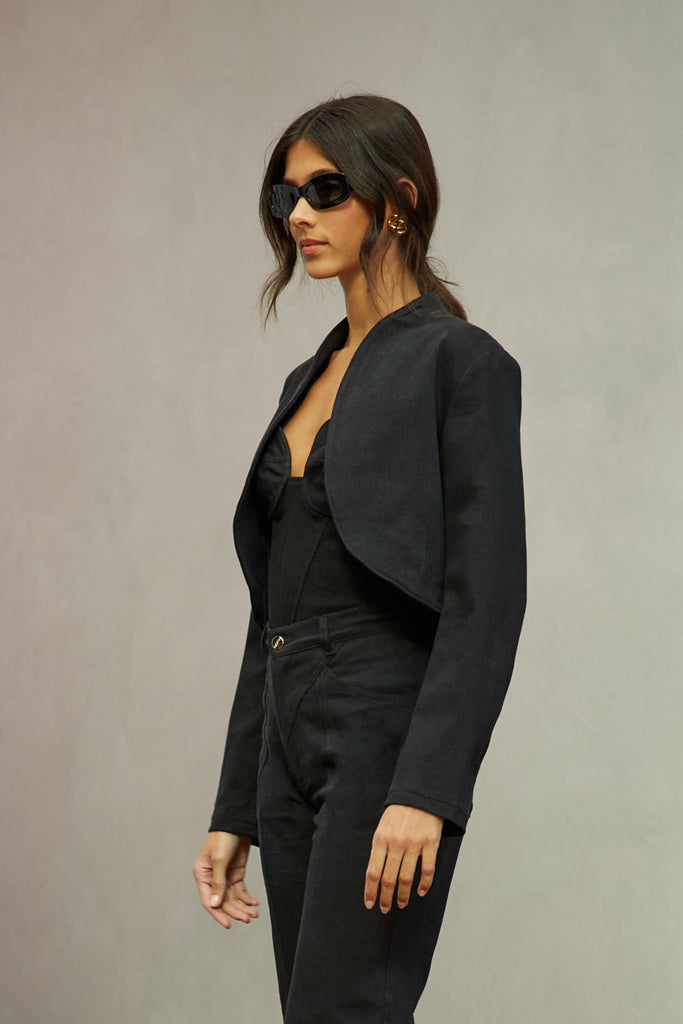 Jet Black Sasha Stretch Bolero This bolero jacket is cut from a lightweight cotton denim elastane blend, designed to feel weightless and breathable during all seasons . It features an open front lapel and cropped length.Styled with The Sarah Stretch Jean | The Chloe Corset