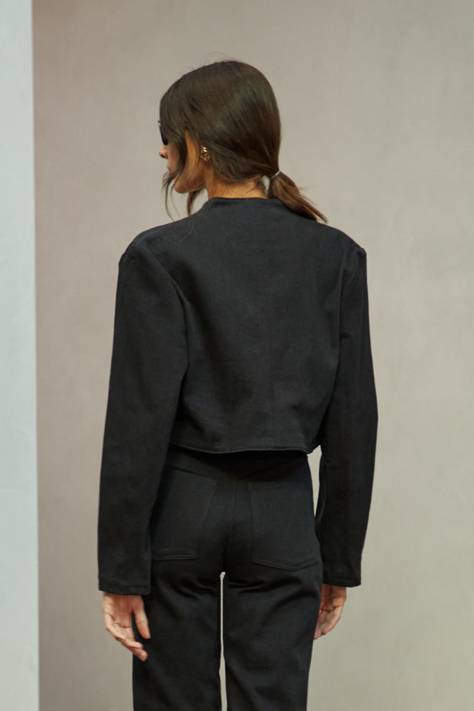 Jet Black Sasha Stretch Bolero This bolero jacket is cut from a lightweight cotton denim elastane blend, designed to feel weightless and breathable during all seasons . It features an open front lapel and cropped length.Styled with The Sarah Stretch Jean | The Chloe Corset