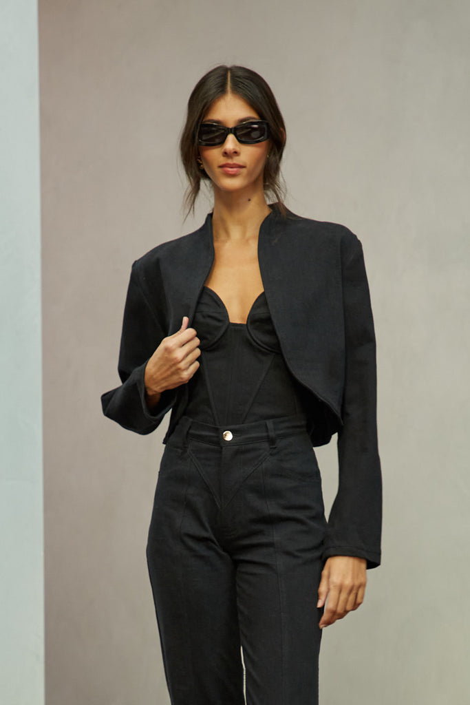 Jet Black Sasha Stretch Bolero This bolero jacket is cut from a lightweight cotton denim elastane blend, designed to feel weightless and breathable during all seasons . It features an open front lapel and cropped length.Styled with The Sarah Stretch Jean | The Chloe Corset