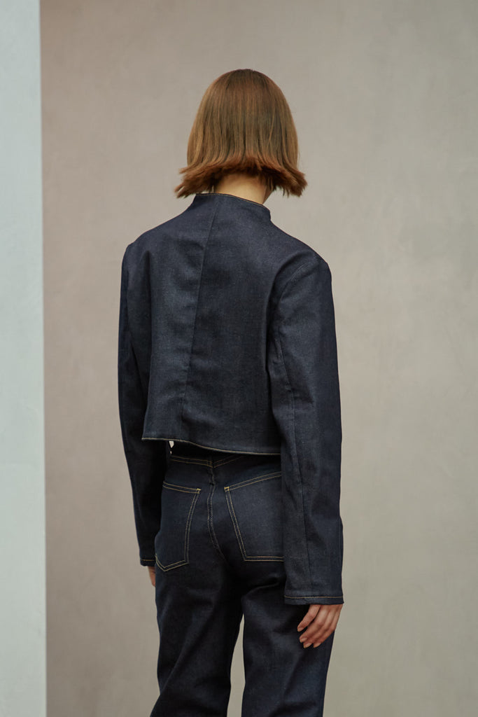 Raw Indigo Sasha Stretch Bolero This bolero jacket is cut from a lightweight cotton denim elastane blend, designed to feel weightless and breathable during all seasons . It features an open front lapel and cropped length.Styled with The Sarah Stretch Jean | The Chloe Corset