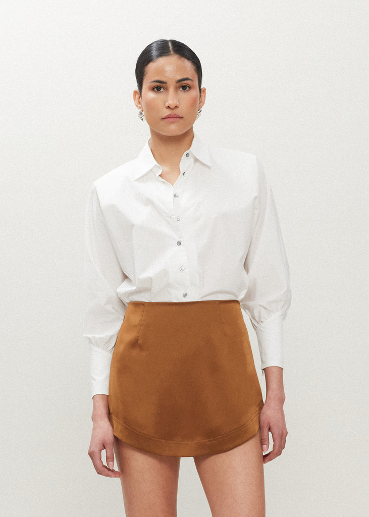 Cinnamon Stella Skirt This vegan silk mini skirt features a flattering curved front and back. Complete with a concealed side zipper and hook and eye closure. *Sale merchandise is exchangeable for size/color or store credit. 