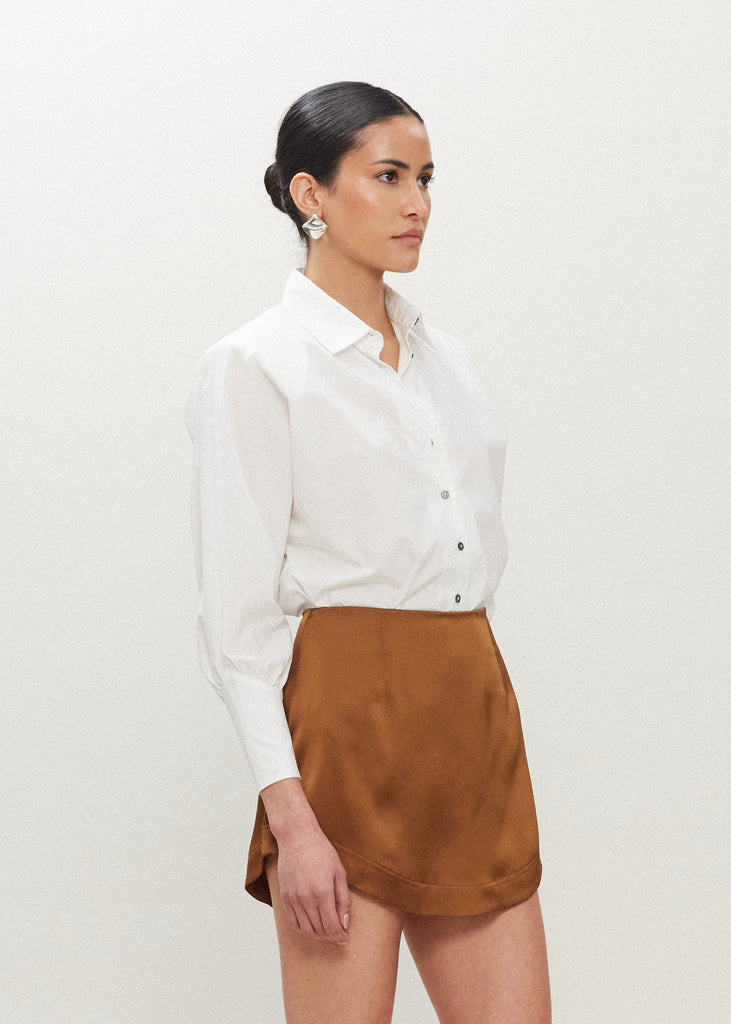 Cinnamon Stella Skirt This vegan silk mini skirt features a flattering curved front and back. Complete with a concealed side zipper and hook and eye closure.  FINAL SALE - EXCHANGE OR STORE CREDIT ONLY