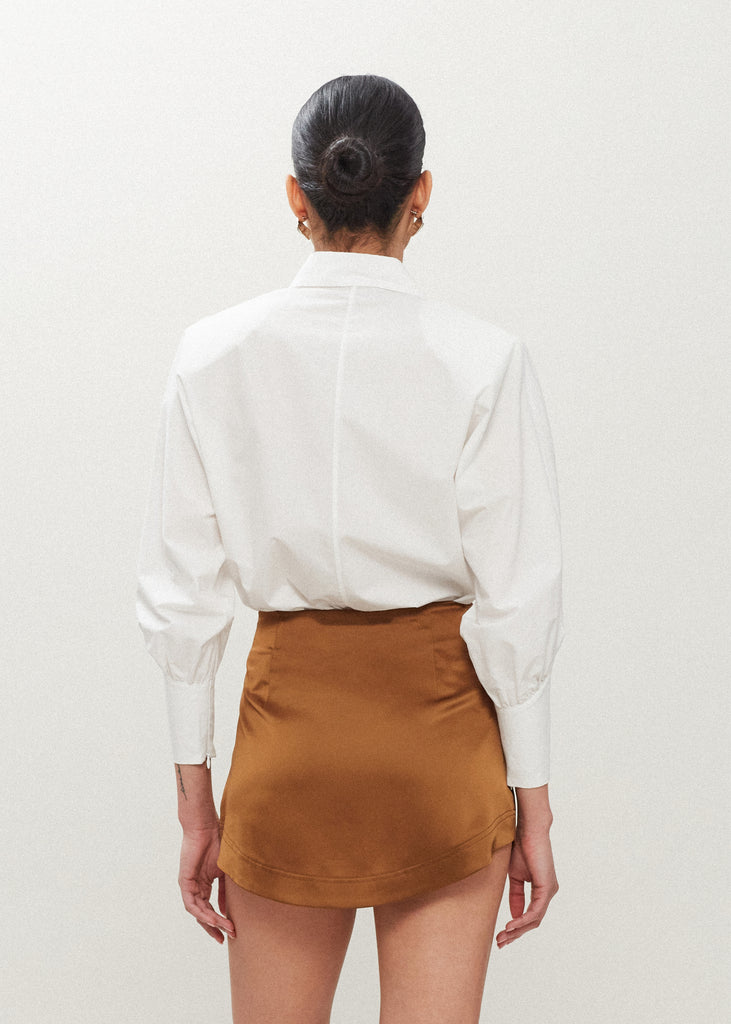 Cinnamon Stella Skirt This vegan silk mini skirt features a flattering curved front and back. Complete with a concealed side zipper and hook and eye closure. *Sale merchandise is exchangeable for size/color or store credit. 