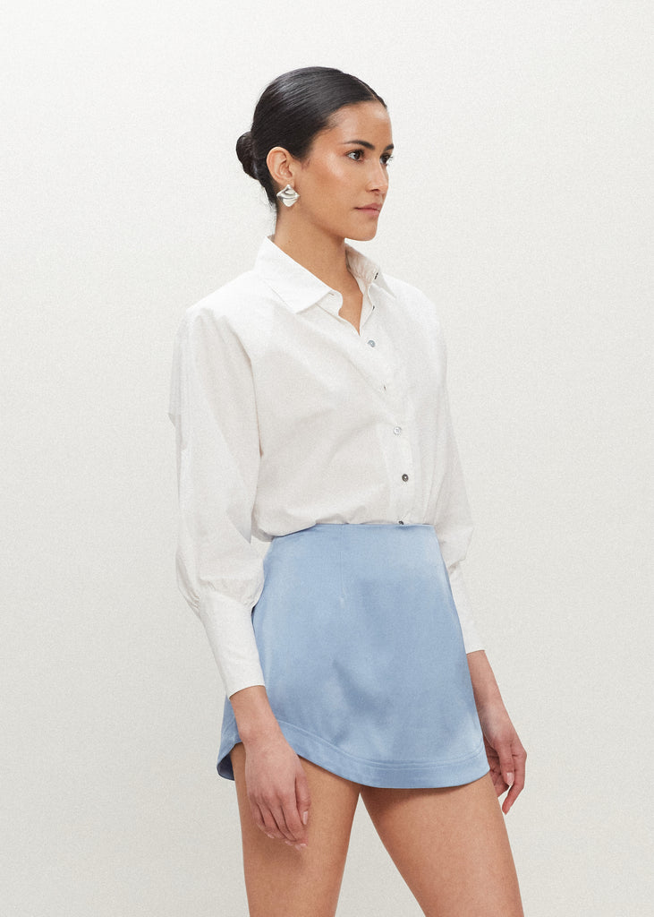 Sky Stella Skirt This vegan silk mini skirt features a flattering curved front and back. Complete with a concealed side zipper and hook and eye closure. *Sale merchandise is exchangeable for size/color or store credit. 