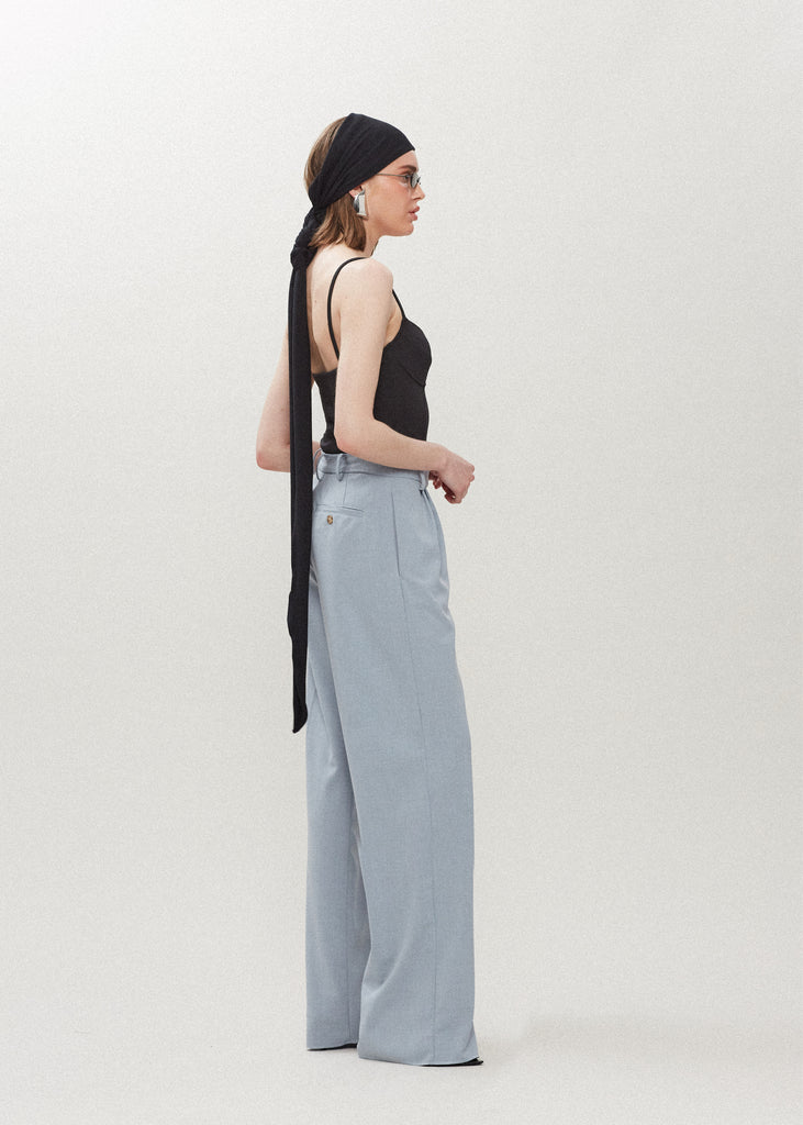 Stone Blue Kat Trouser Dual pleated mid-rise trousers featuring a straight, relaxed fit. Pockets at back with horn buttons. Includes a self-fabric detachable belt. Styled with The Rhodes Blazer | The Lily Bodysuit | The Jamie WrapSALE MERCHANDISE IS EXCHANGE OR STORE CREDIT ONLY