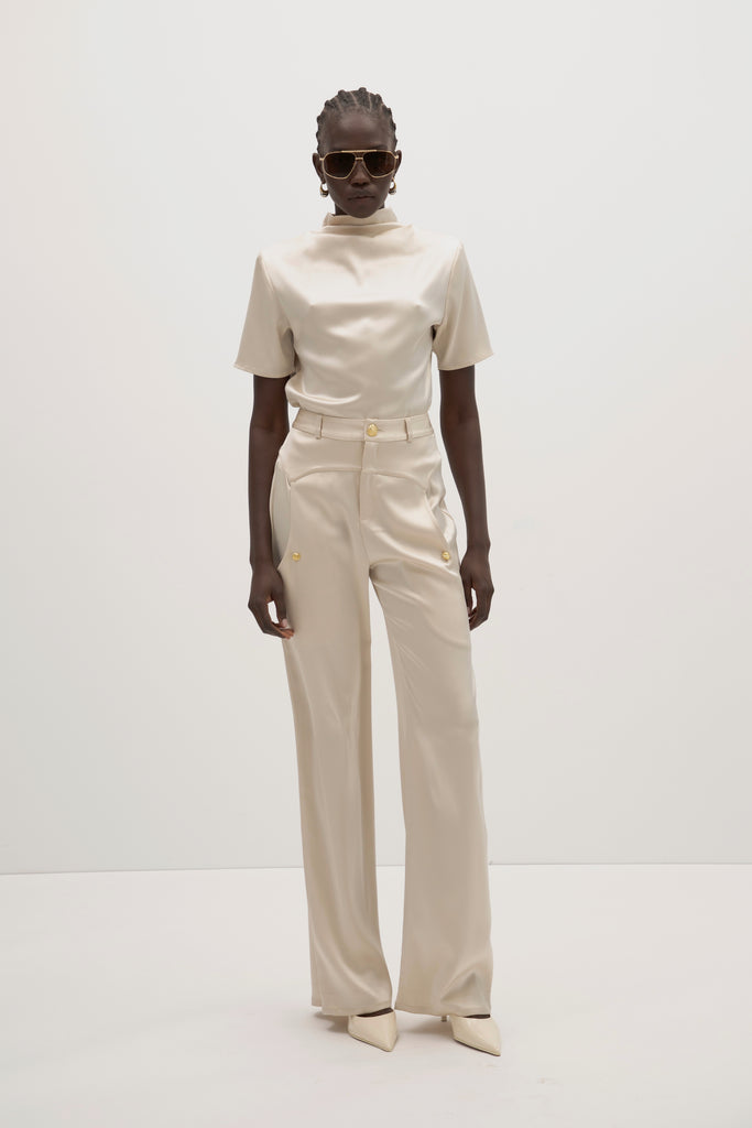 Champagne Vivien Pant -High-rise fit with contrast corset waistband-Gold knot buttons at waist and pockets-Oversized front pockets -Zipper fly with button closure-Clean darts and seamed yoke for shape-Faux welt back pockets-Self-doubled belt loops-31
