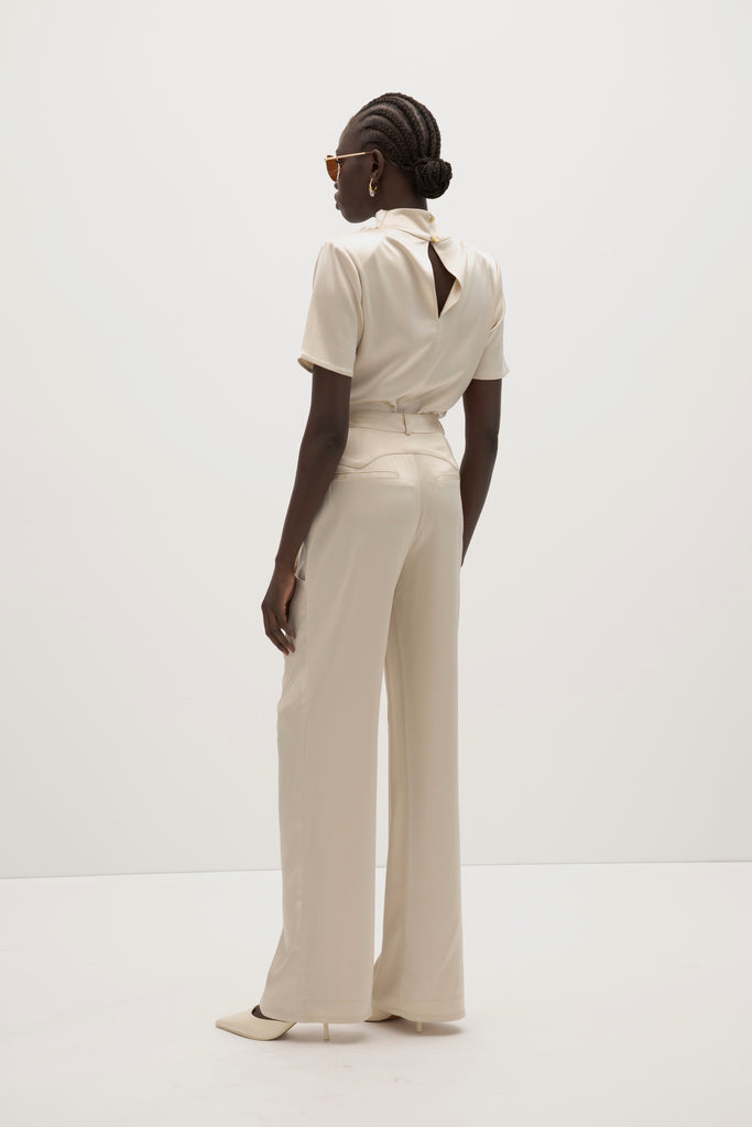 Champagne Vivien Pant -High-rise fit with contrast corset waistband-Gold knot buttons at waist and pockets-Oversized front pockets -Zipper fly with button closure-Clean darts and seamed yoke for shape-Faux welt back pockets-Self-doubled belt loops-31