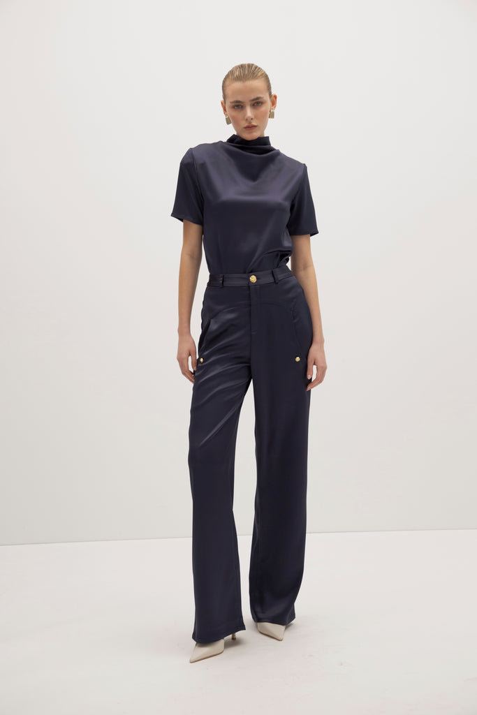 Navy Vivien Pant -High-rise fit with contrast corset waistband-Gold knot buttons at waist and pockets-Oversized front pockets -Zipper fly with button closure-Clean darts and seamed yoke for shape-Faux welt back pockets-Self-doubled belt loops-31