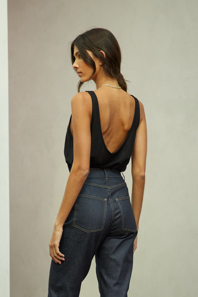 Black Zoey Tank This tank top crafted from premium merino wool features a plunging scoop neckline, low draped back and a lightly sheer finish.Styled with The Sarah Stretch Jean