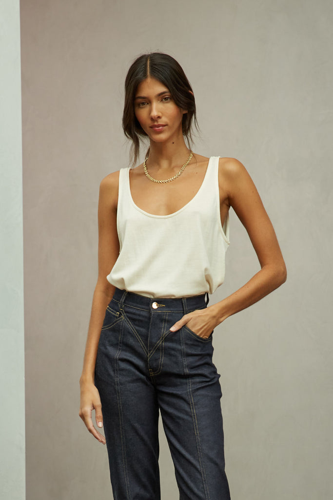 Bone Zoey Tank This tank top crafted from premium merino wool features a plunging scoop neckline, low draped back and a lightly sheer finish.Styled with The Sarah Stretch Jean