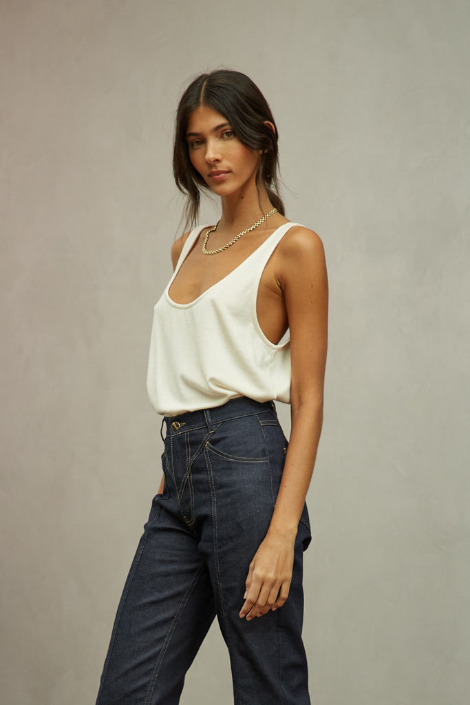 Bone Zoey Tank This tank top crafted from premium merino wool features a plunging scoop neckline, low draped back and a lightly sheer finish.Style with The Sarah Stretch Jean