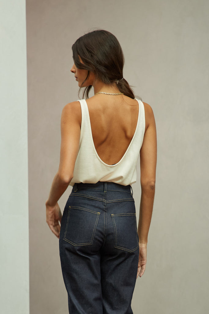 Bone Zoey Tank This tank top crafted from premium merino wool features a plunging scoop neckline, low draped back and a lightly sheer finish.Style with The Sarah Stretch Jean