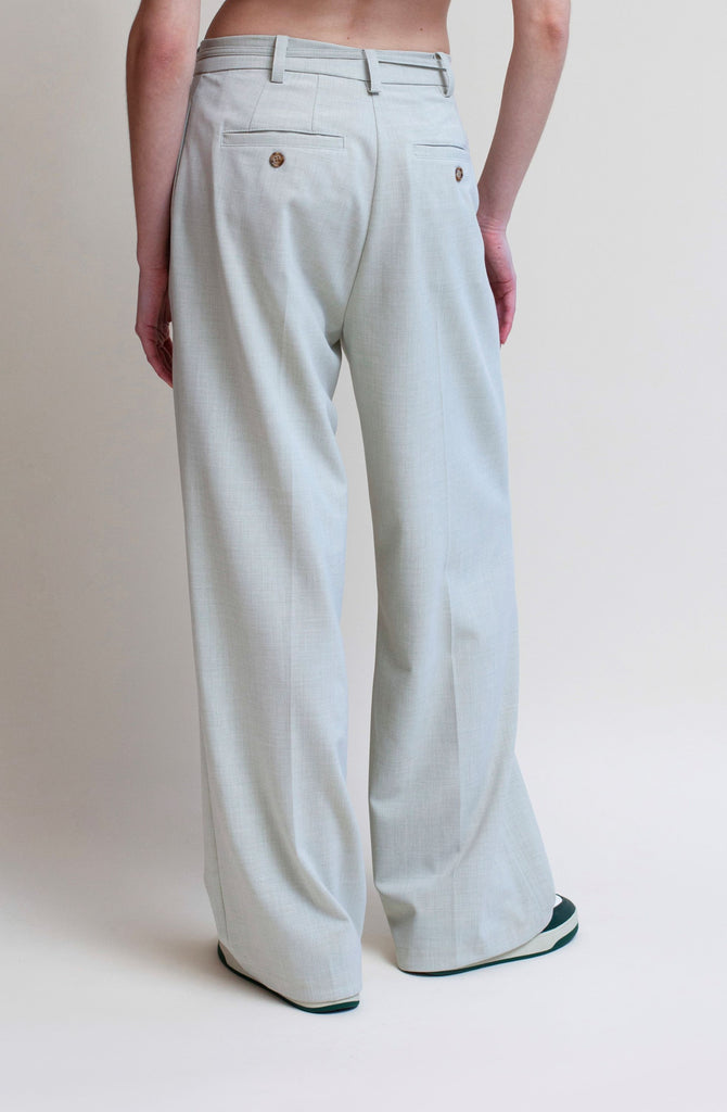 Sage KAT TROUSER Dual pleated mid-rise trousers featuring a straight, relaxed fit. Pockets at back with horn buttons. Includes a self-fabric detachable belt. *All sale merchandise is exchangeable for size only.